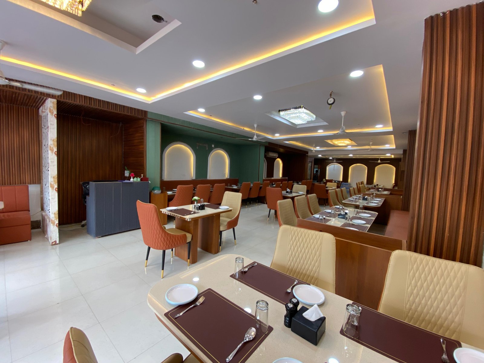 Elegant restaurant interior with white tablecloths, fine china, and candle lighting